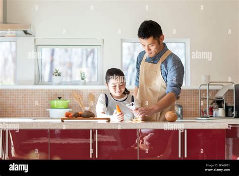 Parent and child cooking in kitchen Stock Photo - Alamy