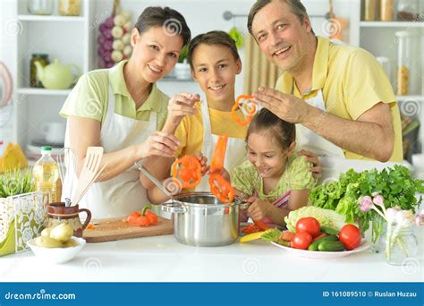 Portrait of Family Cooking Together in Kitchen Stock Photo - Image of ...