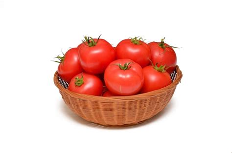 Premium Photo | Fresh tomatoes in a basket isolated on white background
