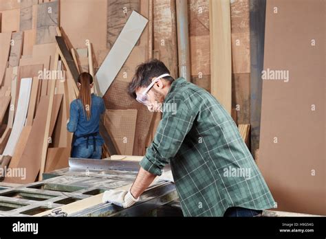 Craftsman as artisan processing wood with machine Stock Photo - Alamy