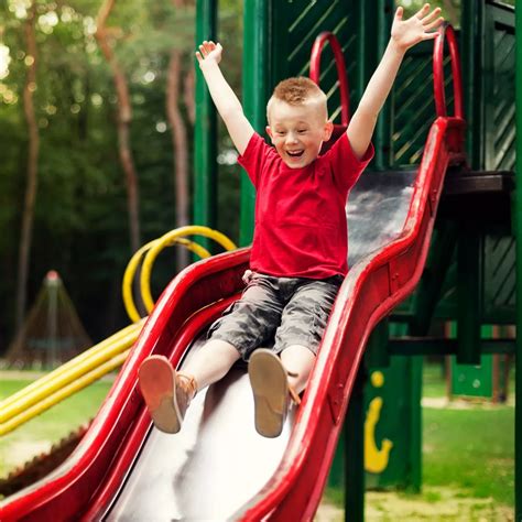 Kid Sliding Down Slide, Active Boy Sliding Down Stock Photo Alamy, Jul ...