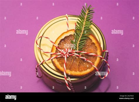 Homemade jam in a decorated jar with orange slice and fir tree twig ...