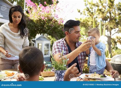 Family at Home Eating Outdoor Meal in Garden Together Stock Image ...