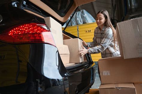 Smiling Grown Woman Packing a Box into the Trunk Stock Photo - Image of ...