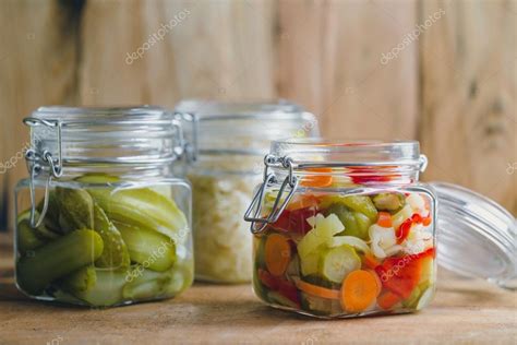 Pickled vegetables in glass jars — Stock Photo © Melica #127742152