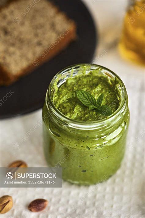 Homemade basil and arugula pesto in a jar - SuperStock