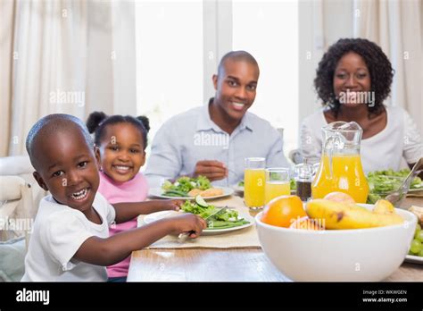 Happy family enjoying a healthy meal together at home in the kitchen ...