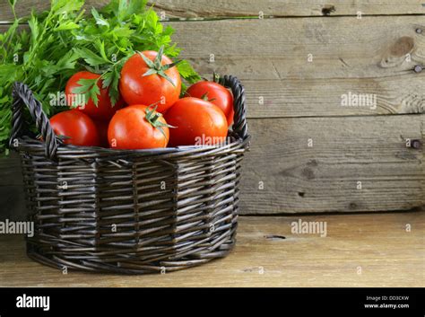 fresh ripe tomatoes in a basket on the table Stock Photo - Alamy